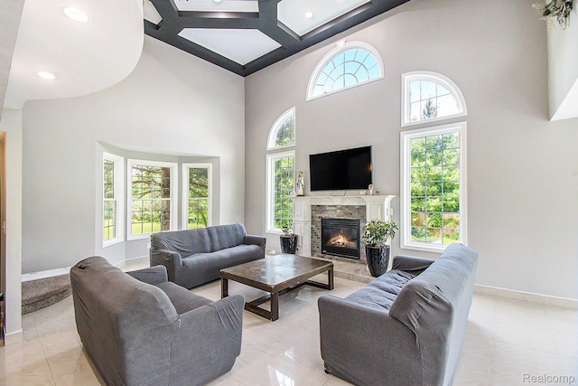 7471 Brewer Rd, Flint, MI 48507 - living area featuring a high ceiling, a glass covered fireplace, and recessed lighting