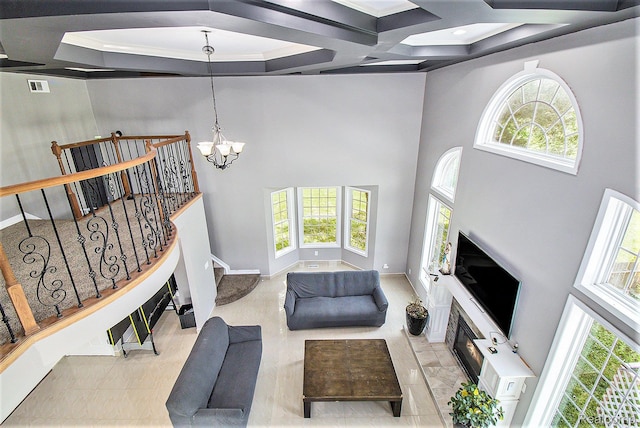 7471 Brewer Rd, Flint, MI 48507 - living area with a chandelier, coffered ceiling, a high ceiling, ornamental molding, and beam ceiling