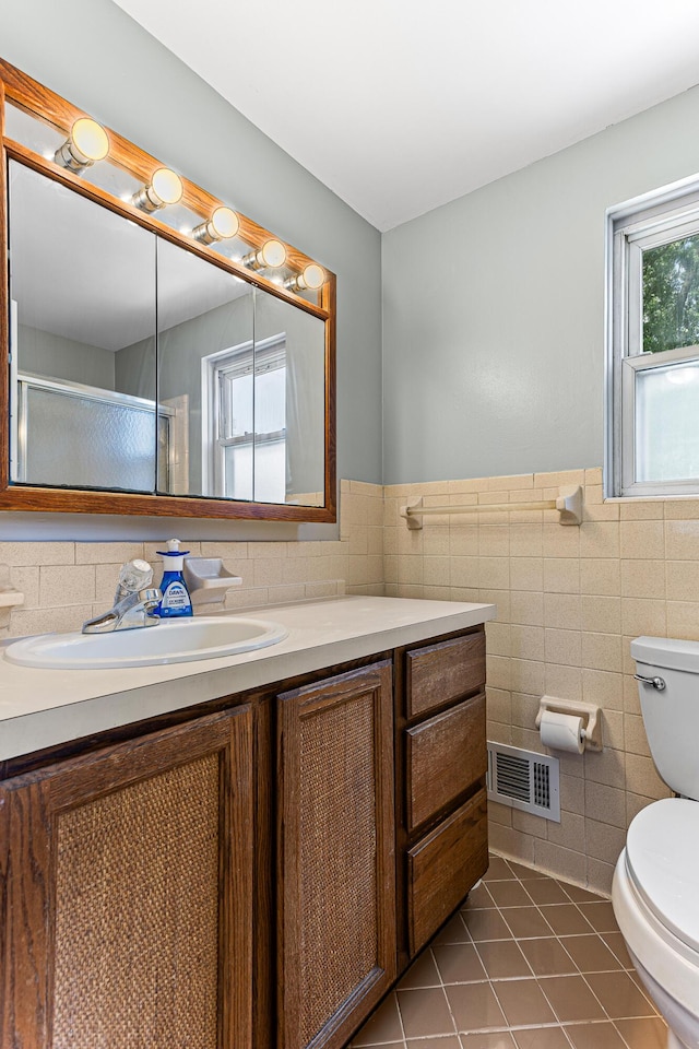 771 S Venoy Rd, Westland, MI 48186 - full bathroom with vanity, tile walls, tile patterned floors, a shower with shower door, and wainscoting