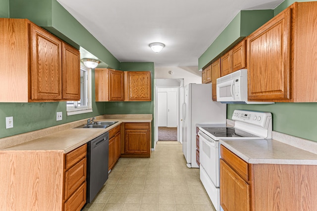 771 S Venoy Rd, Westland, MI 48186 - kitchen with white appliances, light countertops, and brown cabinetry