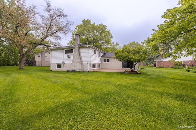 4290 Frostwood, Troy, MI 48098 - back of property with a patio, a chimney, a yard, and brick siding