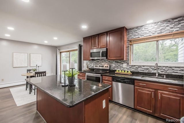4290 Frostwood, Troy, MI 48098 - kitchen with stainless steel appliances, a baseboard heating unit, decorative backsplash, recessed lighting, and dark wood-type flooring