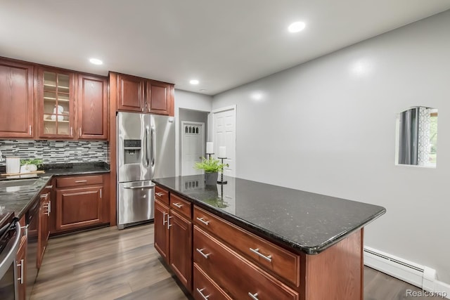 4290 Frostwood, Troy, MI 48098 - kitchen featuring stainless steel appliances, a baseboard radiator, wood finished floors, a kitchen island, and tasteful backsplash