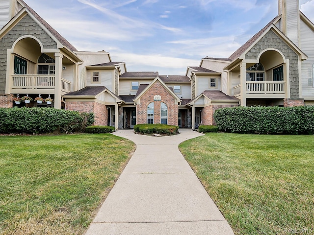 229 Brookwood Dr Unit 9, South Lyon, MI 48178 - view of front of house with a front lawn and brick siding