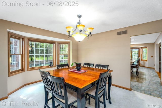 8123 Baypointe Dr, Brighton, MI 48114 - dining space featuring a chandelier and light colored carpet