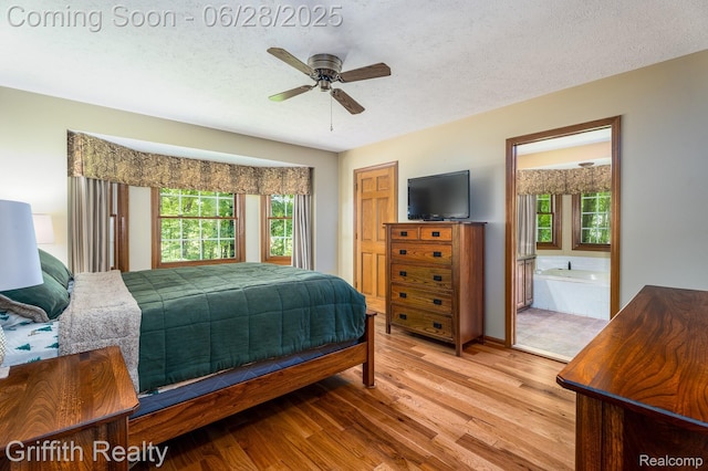 8123 Baypointe Dr, Brighton, MI 48114 - bedroom featuring wood finished floors, a textured ceiling, ensuite bathroom, and ceiling fan