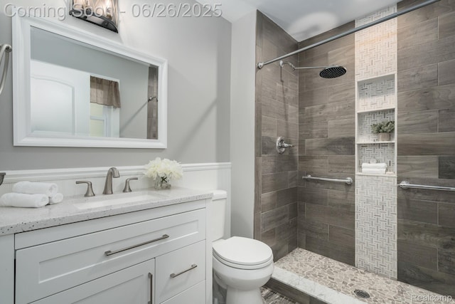 2905 Lahser Rd, Bloomfield Hills, MI 48304 - bathroom featuring tiled shower, vanity, and a wainscoted wall
