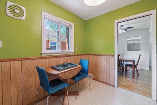 13210 Tecumseh Ave, Redford, MI 48239 - dining area featuring wainscoting, a ceiling fan, and wooden walls