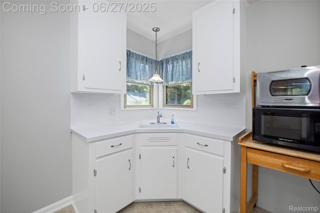 17381 Lennane, Redford, MI 48240 - kitchen featuring white cabinetry, light countertops, and pendant lighting