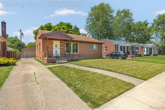17381 Lennane, Redford, MI 48240 - view of front facade featuring brick siding, a detached garage, and an outbuilding