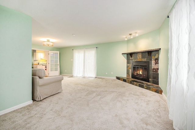 1621 Whittier Rd, Ypsilanti, MI 48197 - unfurnished living room featuring a stone fireplace and carpet flooring