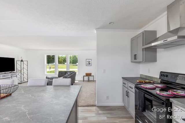 19150 Yankee Rd, Morley, MI 49336 - kitchen featuring black range with electric cooktop, wall chimney exhaust hood, ornamental molding, gray cabinetry, and open floor plan