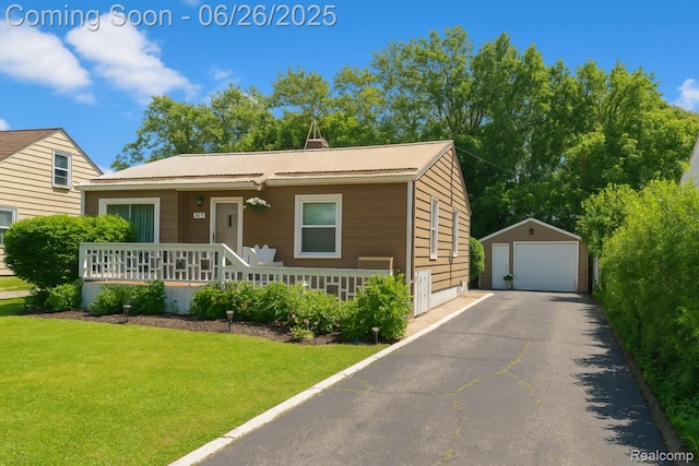607 Chalmers St, Flint, MI 48503 - view of front of home with a garage, an outbuilding, covered porch, a front yard, and a metal roof