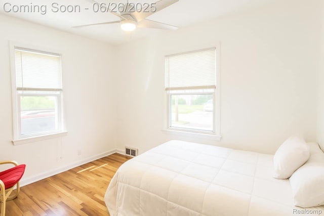 607 Chalmers St, Flint, MI 48503 - bedroom with multiple windows, wood finished floors, and ceiling fan