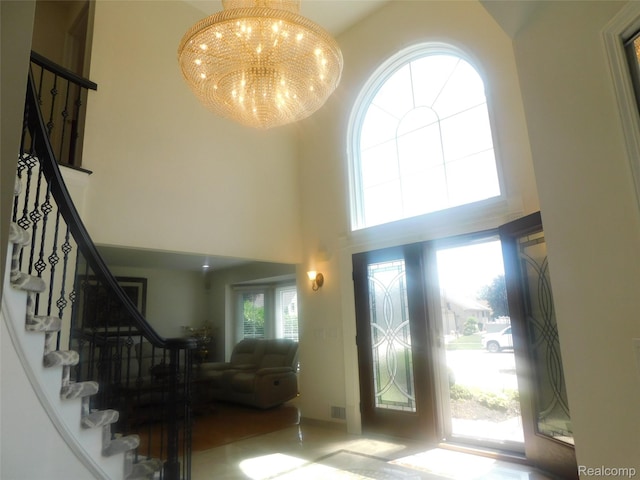 41431 Tarragon Dr, Sterling Heights, MI 48314 - entrance foyer featuring a high ceiling, stairs, and a chandelier
