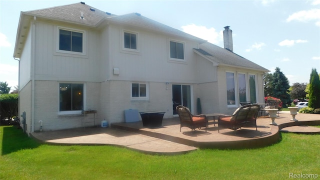 41431 Tarragon Dr, Sterling Heights, MI 48314 - back of house featuring a patio area, a chimney, brick siding, and a yard