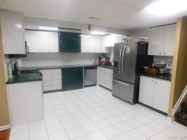 41431 Tarragon Dr, Sterling Heights, MI 48314 - kitchen featuring stainless steel appliances, dark countertops, a paneled ceiling, and white cabinetry