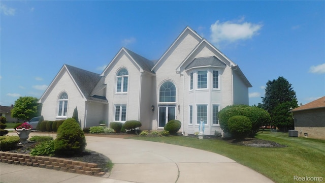 41431 Tarragon Dr, Sterling Heights, MI 48314 - view of front of home with brick siding and a front lawn