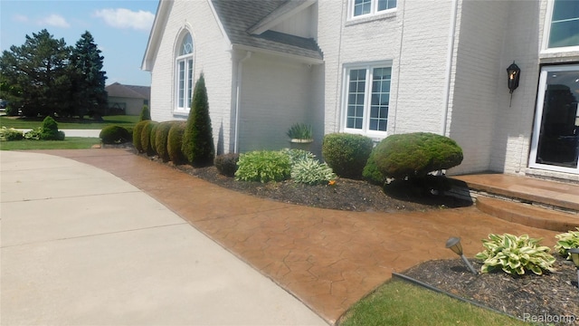 41431 Tarragon Dr, Sterling Heights, MI 48314 - view of home's exterior with brick siding and a shingled roof