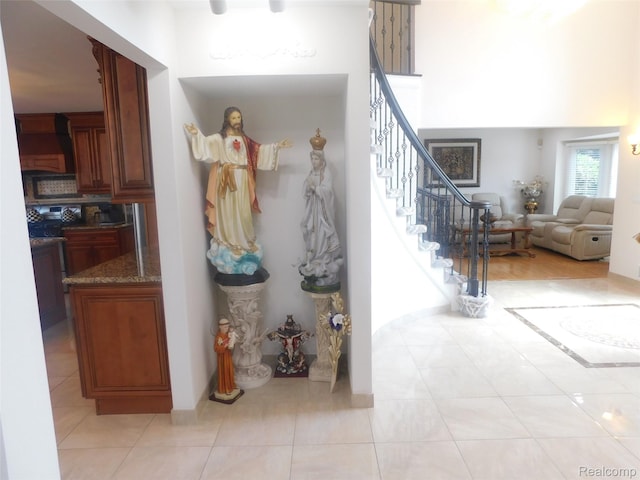 41431 Tarragon Dr, Sterling Heights, MI 48314 - entrance foyer featuring stairway, light tile patterned floors, and a towering ceiling