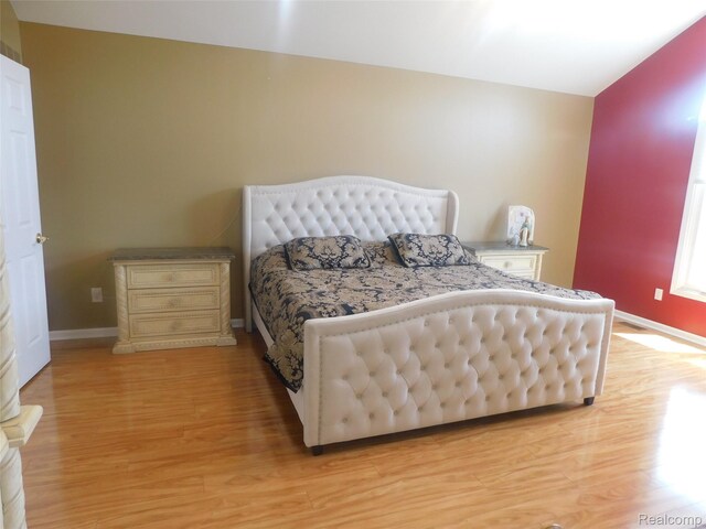 41431 Tarragon Dr, Sterling Heights, MI 48314 - bedroom with light wood finished floors and lofted ceiling