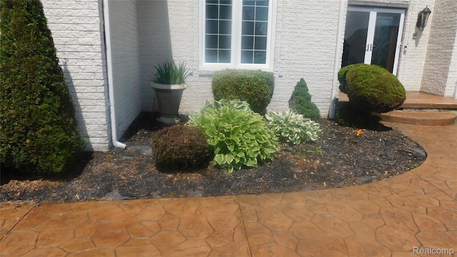 41431 Tarragon Dr, Sterling Heights, MI 48314 - view of side of home with french doors and brick siding