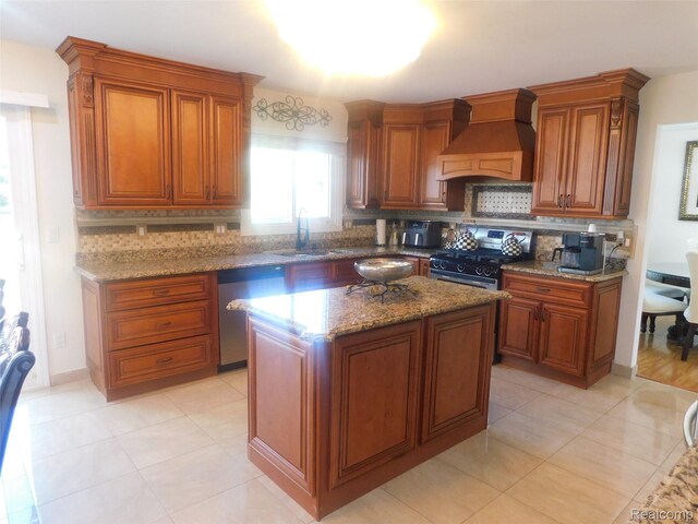 41431 Tarragon Dr, Sterling Heights, MI 48314 - kitchen with custom exhaust hood, black range with gas cooktop, stainless steel dishwasher, and tasteful backsplash