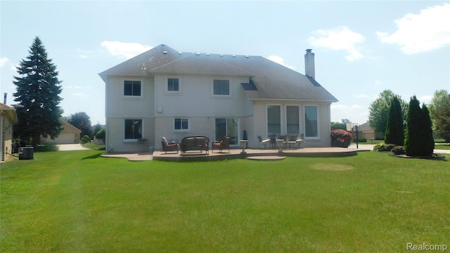 41431 Tarragon Dr, Sterling Heights, MI 48314 - back of house with a patio, a chimney, and a lawn