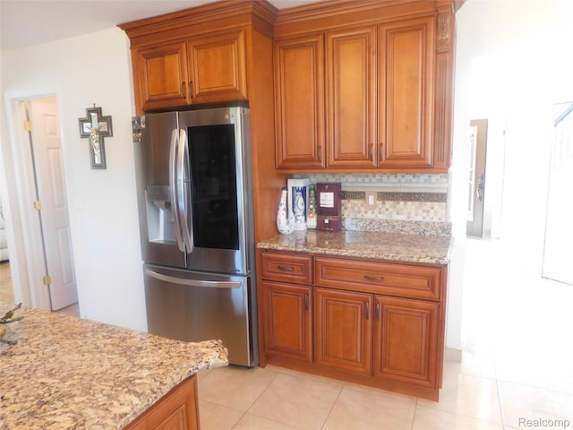 41431 Tarragon Dr, Sterling Heights, MI 48314 - kitchen featuring stainless steel refrigerator with ice dispenser, brown cabinets, and light stone counters