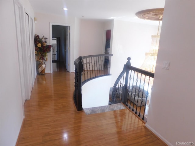 41431 Tarragon Dr, Sterling Heights, MI 48314 - hallway with an upstairs landing, wood finished floors, and recessed lighting