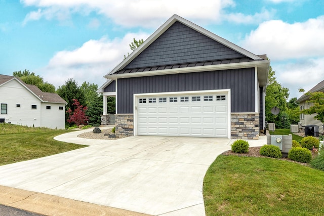 5332 Harborview Pass, Kalamazoo, MI 49009 - view of front of home featuring board and batten siding, stone siding, a standing seam roof, a front lawn, and a metal roof