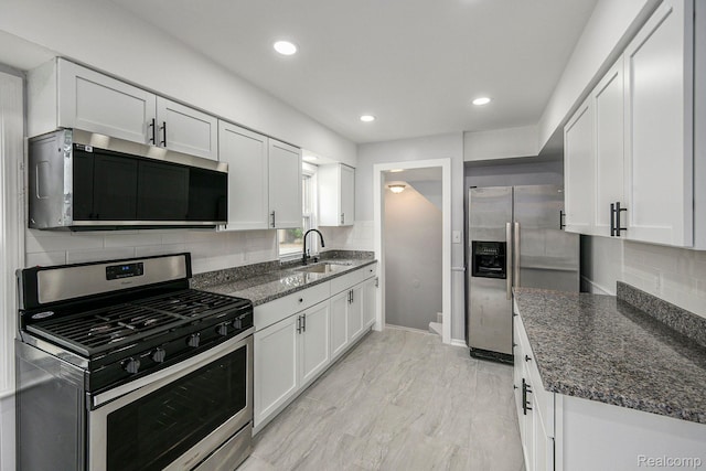 2856 Academy St, Dearborn, MI 48124 - kitchen featuring appliances with stainless steel finishes, tasteful backsplash, white cabinetry, recessed lighting, and dark stone countertops