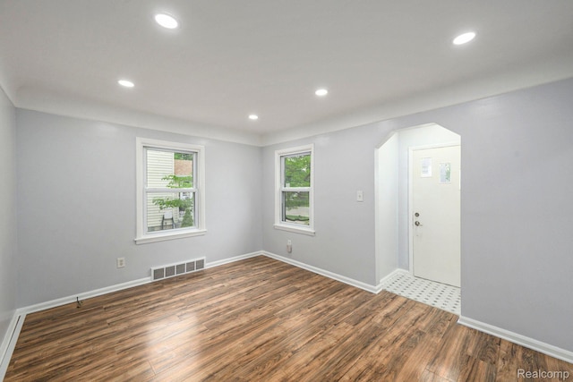 2856 Academy St, Dearborn, MI 48124 - empty room with wood finished floors, arched walkways, and recessed lighting
