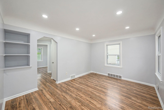 2856 Academy St, Dearborn, MI 48124 - empty room with arched walkways, wood finished floors, and recessed lighting