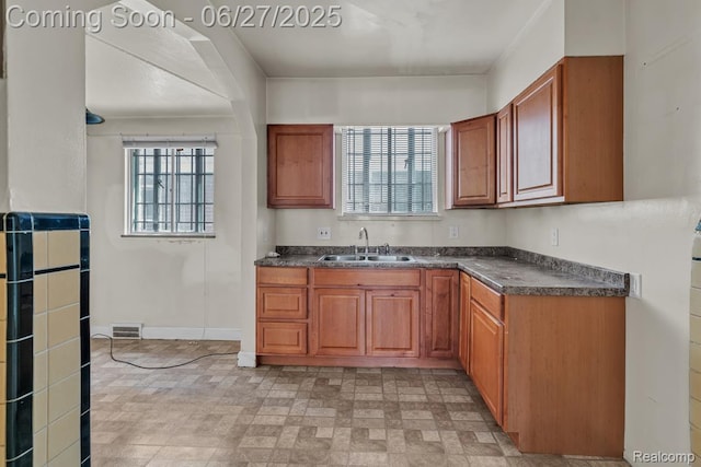2675 Fleet St, Detroit, MI 48238 - kitchen with dark countertops and brown cabinetry