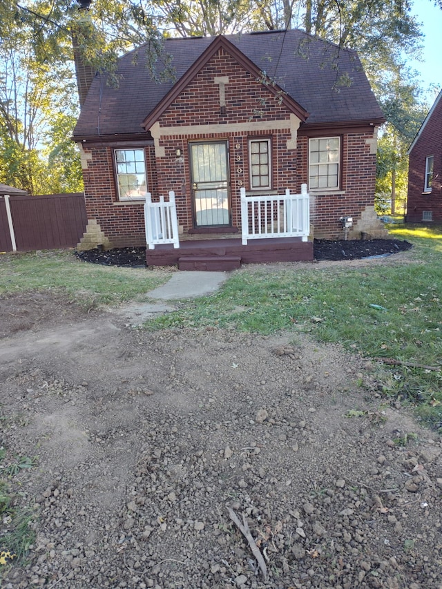 6303 Guilford St, Detroit, MI 48224 - view of front of property with brick siding, a chimney, and roof with shingles