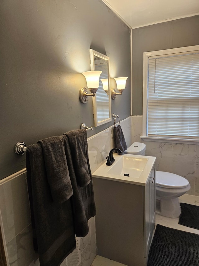 6303 Guilford St, Detroit, MI 48224 - bathroom with tile walls, vanity, and a wainscoted wall