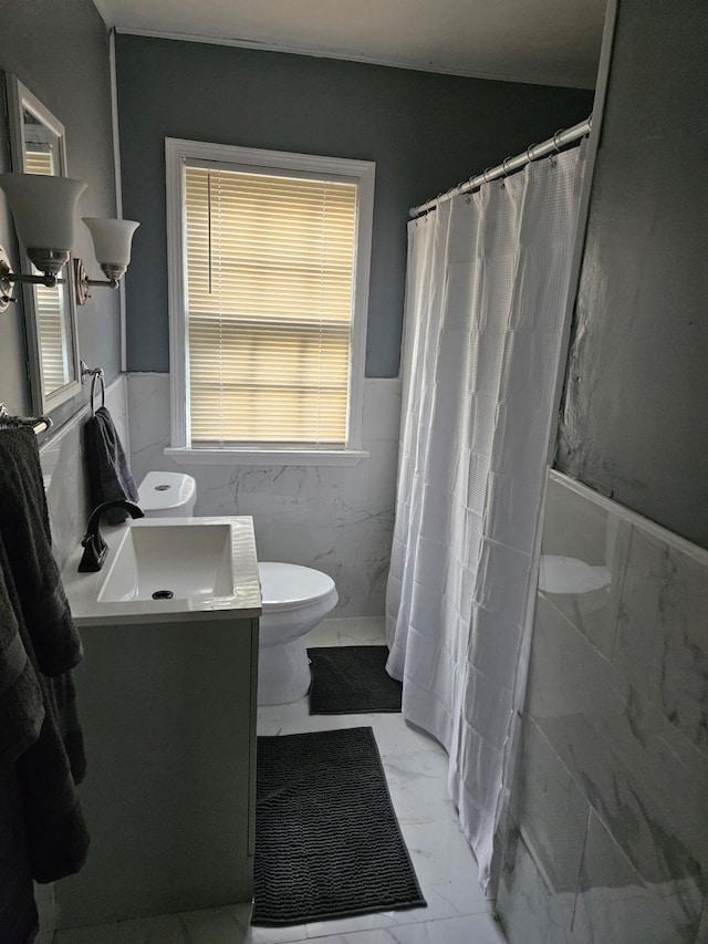 6303 Guilford St, Detroit, MI 48224 - bathroom featuring tile walls, marble finish flooring, wainscoting, vanity, and a shower with shower curtain