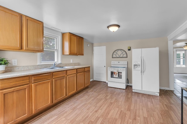 123 Fairview St, Hanover, MI 49241 - kitchen with white appliances, light countertops, light wood-style floors, and brown cabinetry
