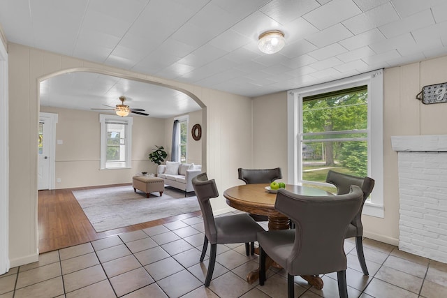 123 Fairview St, Hanover, MI 49241 - dining area featuring arched walkways, ceiling fan, and light tile patterned floors