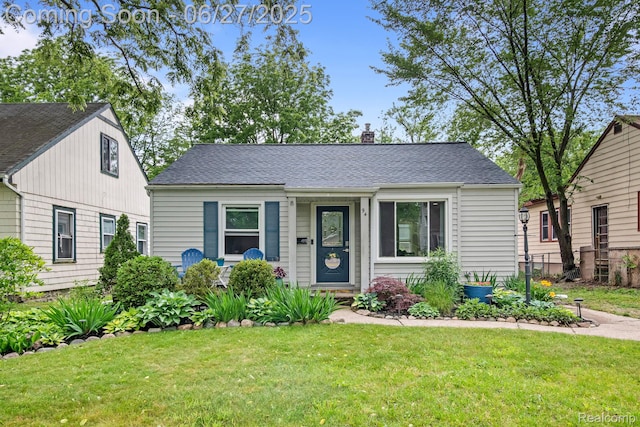 94 S Tilden Ave, Waterford, MI 48328 - view of front of home with a chimney and a shingled roof