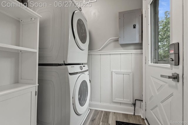 94 S Tilden Ave, Waterford, MI 48328 - washroom with stacked washing machine and dryer, electric panel, and wood finished floors