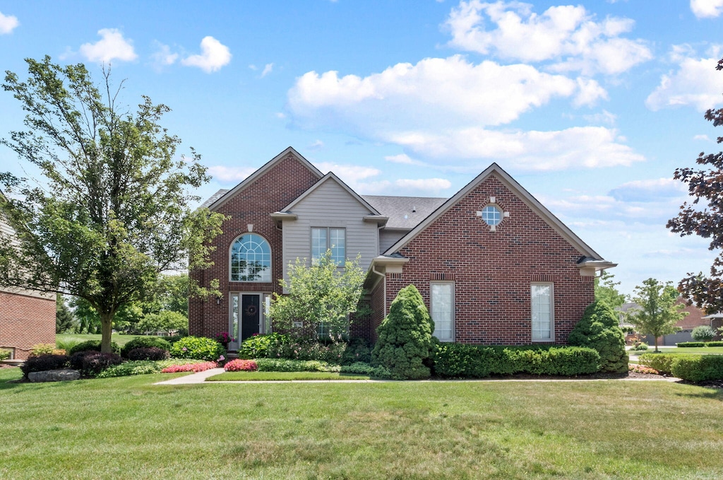 51069 Richard Dr, Plymouth, MI 48170 - traditional-style house with brick siding and a front yard