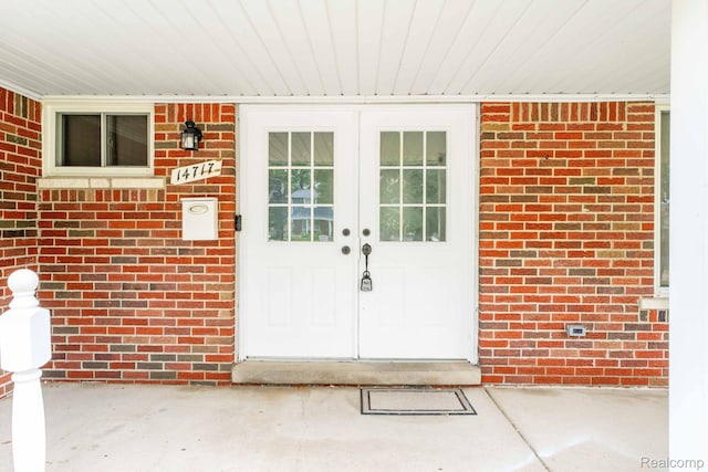 14717 Dane Ct, Sterling Heights, MI 48312 - view of exterior entry featuring french doors and brick siding