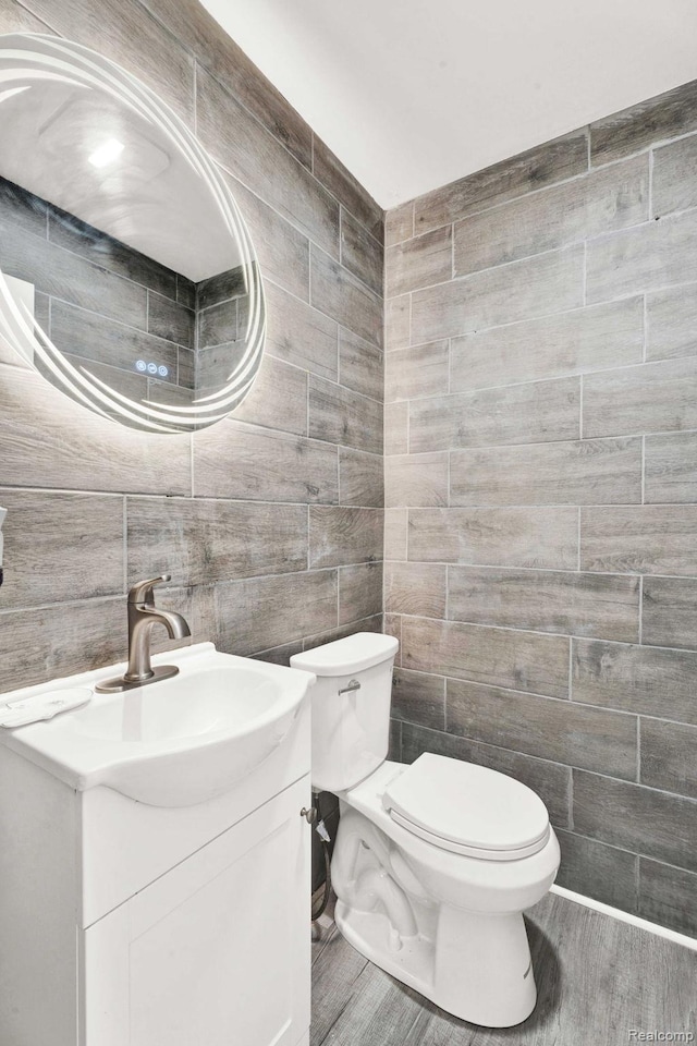 14717 Dane Ct, Sterling Heights, MI 48312 - bathroom with vanity, tile walls, and wood finished floors