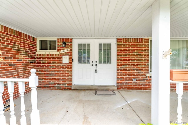 14717 Dane Ct, Sterling Heights, MI 48312 - view of exterior entry with french doors and brick siding