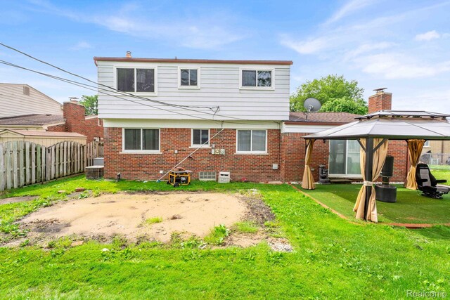 14717 Dane Ct, Sterling Heights, MI 48312 - rear view of property featuring a gazebo, brick siding, and a chimney