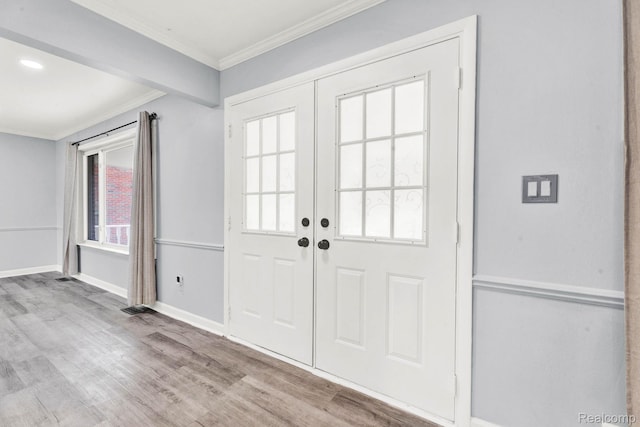 14717 Dane Ct, Sterling Heights, MI 48312 - entryway with wood finished floors, ornamental molding, and french doors