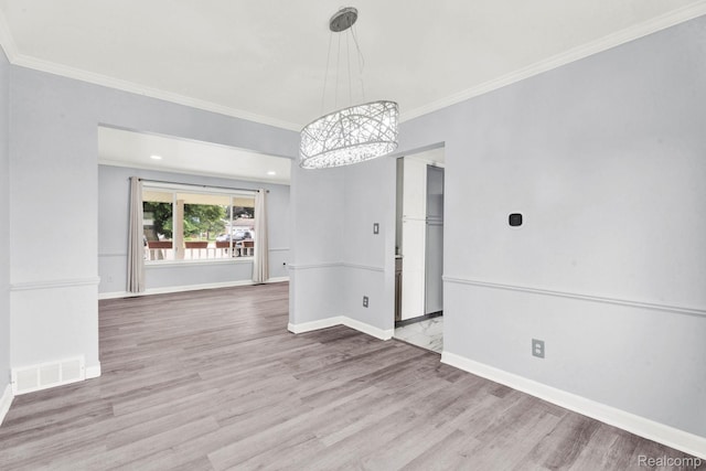 14717 Dane Ct, Sterling Heights, MI 48312 - empty room featuring a chandelier, crown molding, and wood finished floors