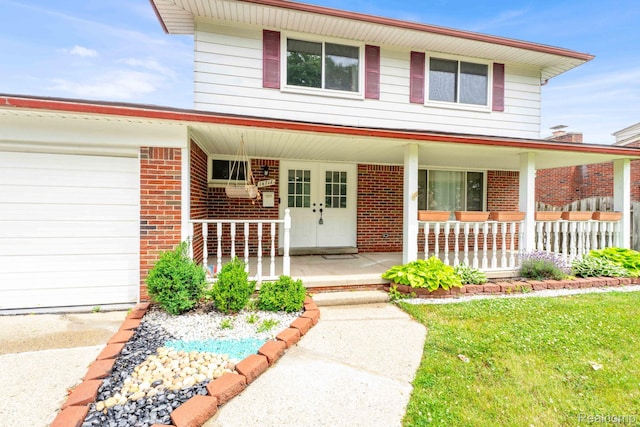 14717 Dane Ct, Sterling Heights, MI 48312 - view of front of property with covered porch, an attached garage, and brick siding